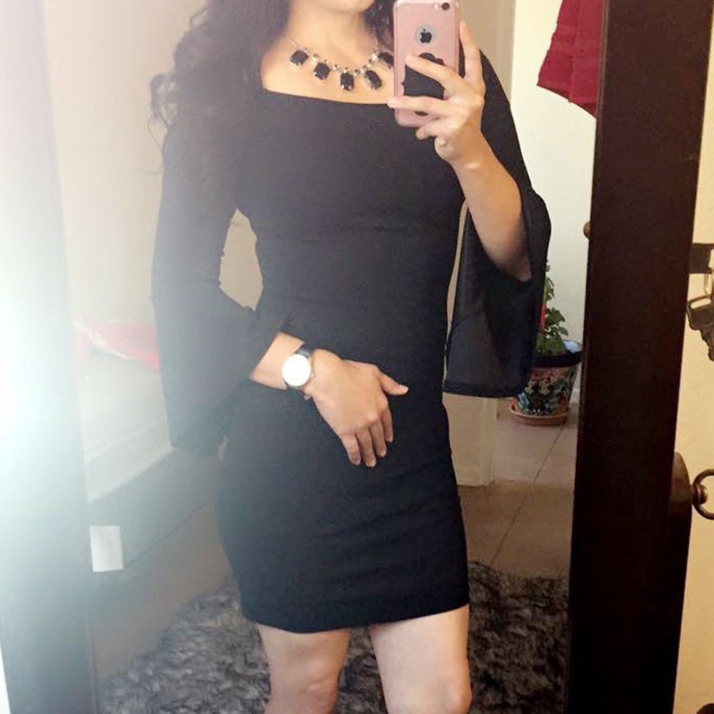 Women’s black dress, short, flare sleeve.